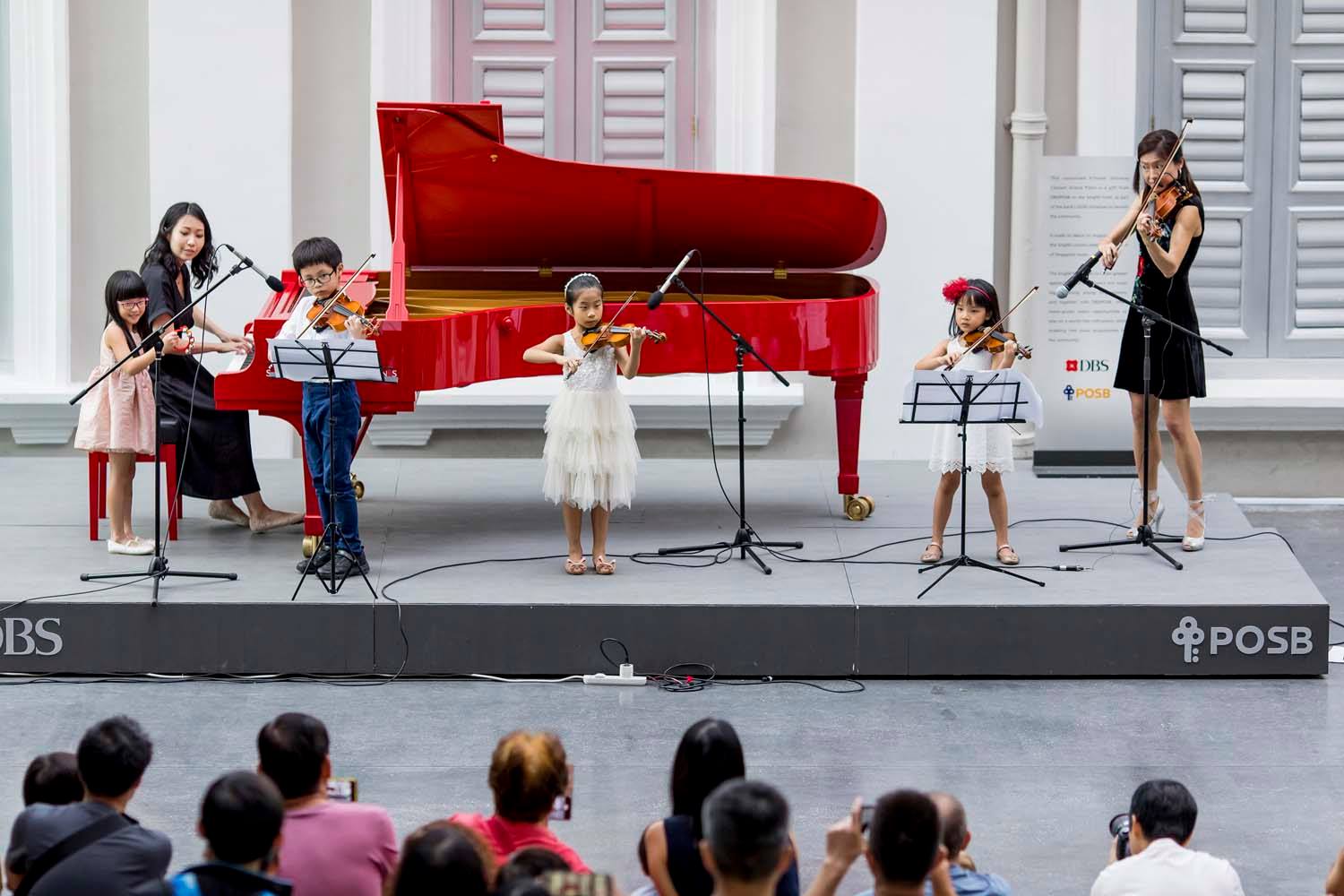 Eileen performing with her student violinists at the National Musuem. Pic by Nigel Lau